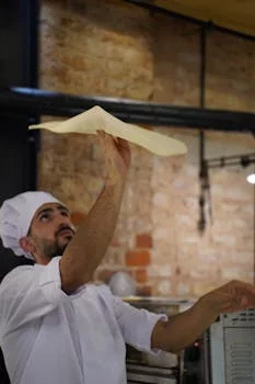 pizza chef tossing dough expertly